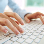 Hands of an office woman typing