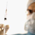 Surgeon holding injection vaccine