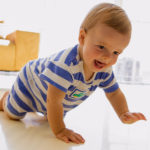 Baby crawling in living room