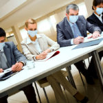 Portrait of group of business partners in protective masks during work