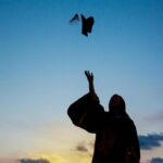 Silhouette Of Young Female Student Celebrating Graduation