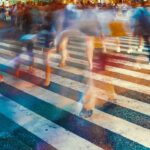 Motion blurred crowds converge at Shibuya Crossing, Tokyo, Japan