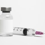 Blank white label on injection bottle glass vial with syringe